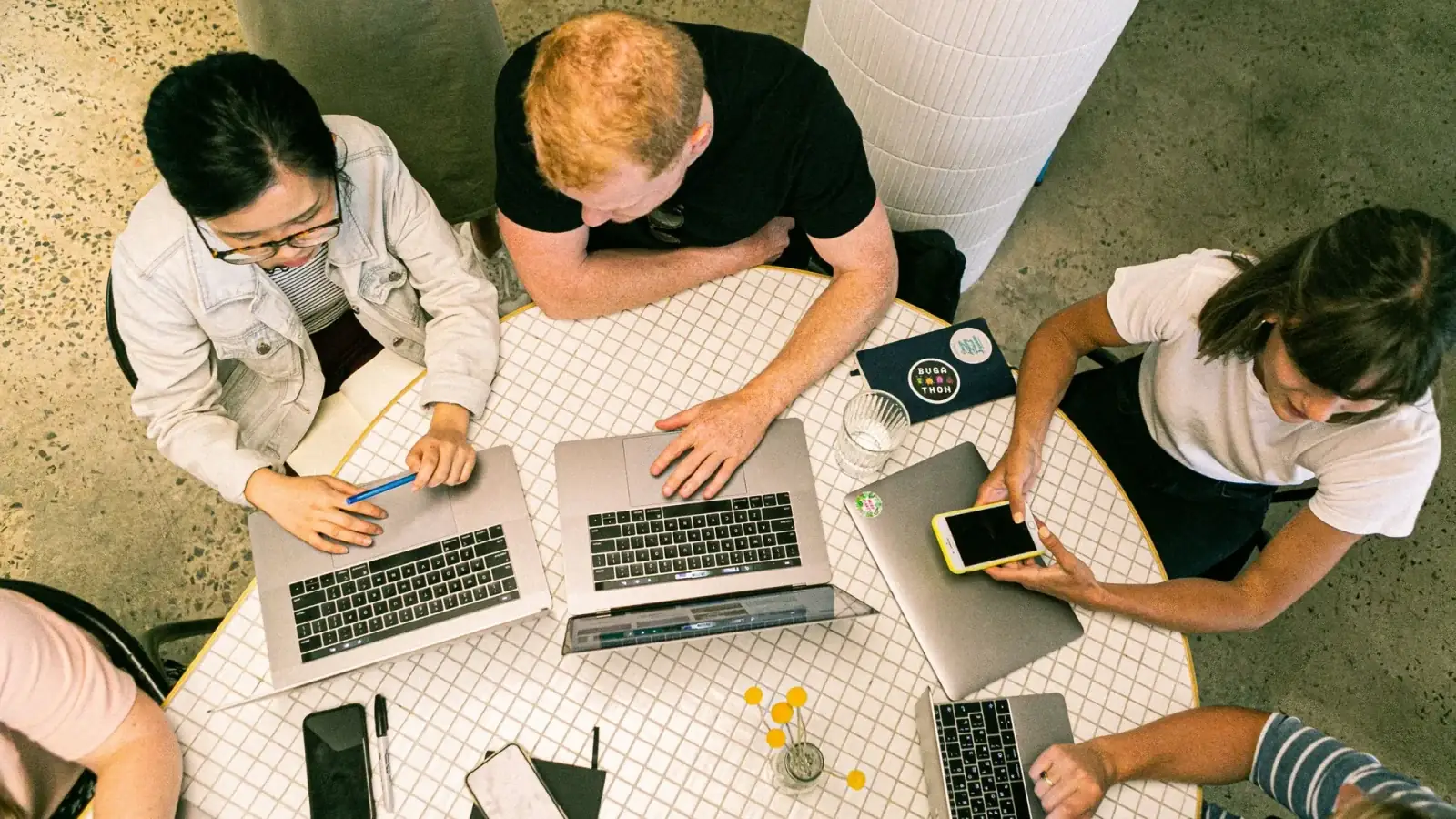 Top view of diverse team collaboratively working in a modern office setting.